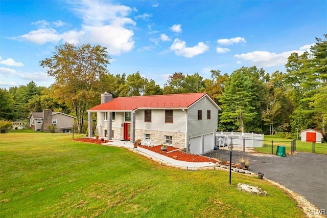 back of property with a storage shed, a yard, and a garage