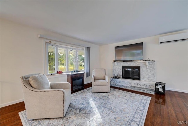 living room featuring hardwood / wood-style flooring and a wall mounted AC