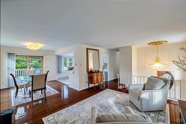 living room featuring dark hardwood / wood-style flooring, a baseboard radiator, and a notable chandelier