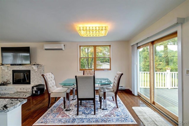 dining space with a wall mounted AC and hardwood / wood-style flooring