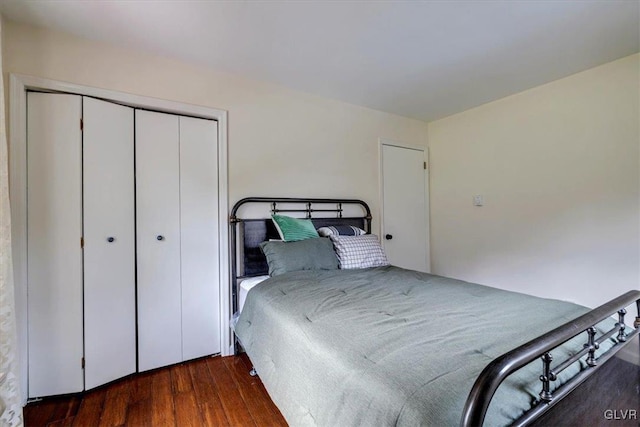 bedroom featuring a closet and dark hardwood / wood-style flooring