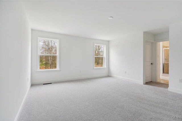 spare room featuring light colored carpet