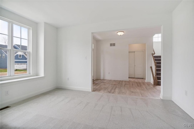 carpeted empty room with plenty of natural light