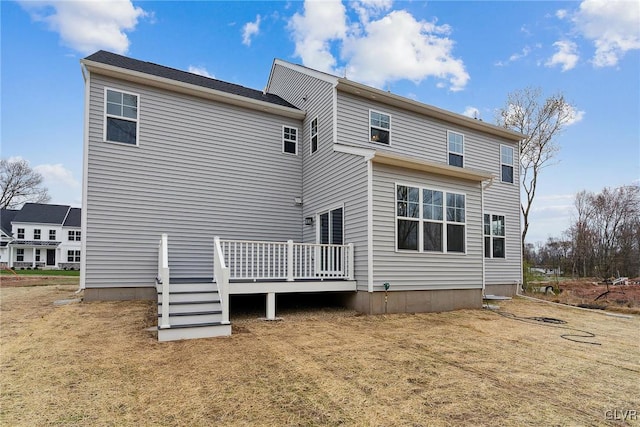 rear view of property featuring a deck