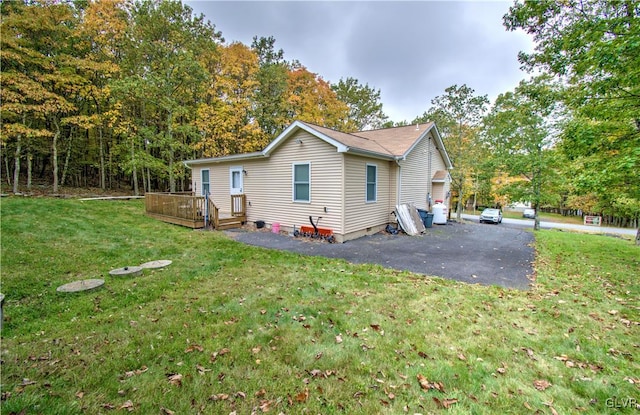 back of house featuring a deck and a yard