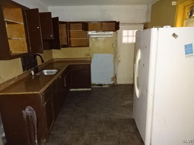 kitchen with sink, dark parquet floors, and white fridge