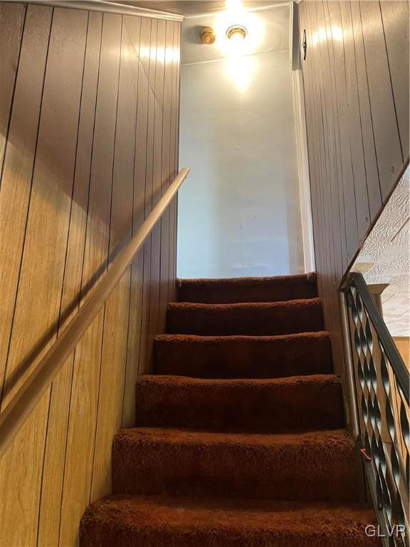 stairway with wood walls