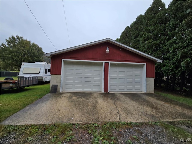 garage featuring a lawn