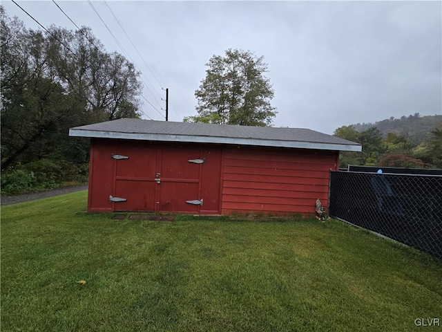 view of outdoor structure featuring a yard