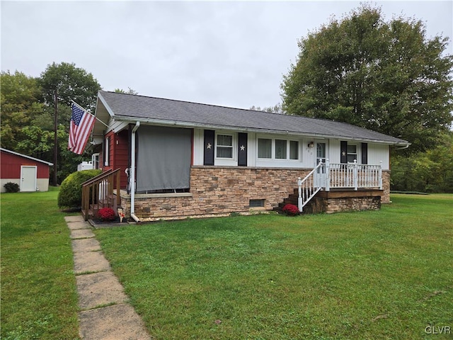 ranch-style house featuring a front lawn and an outbuilding