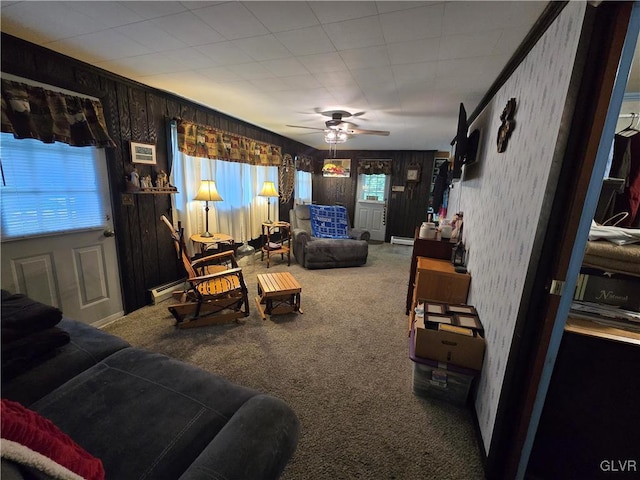 carpeted living room featuring ceiling fan and a wealth of natural light