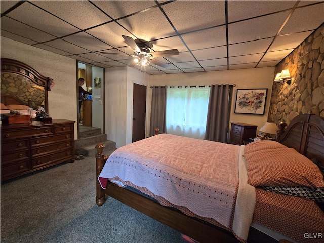 carpeted bedroom featuring a drop ceiling and ceiling fan