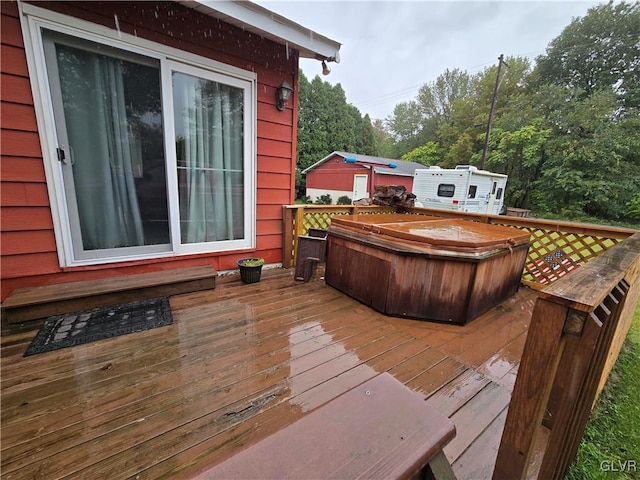 wooden terrace featuring a hot tub