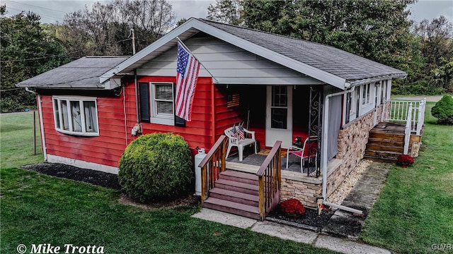 bungalow-style home featuring a front yard