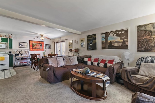 carpeted living room featuring ceiling fan and beamed ceiling