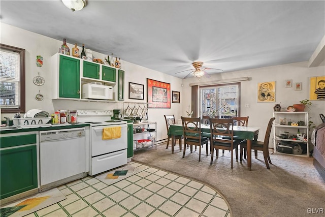 kitchen featuring sink, green cabinetry, light carpet, white appliances, and ceiling fan