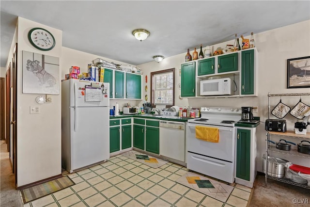 kitchen with green cabinets, white appliances, and sink