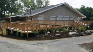 back of house with a wooden deck