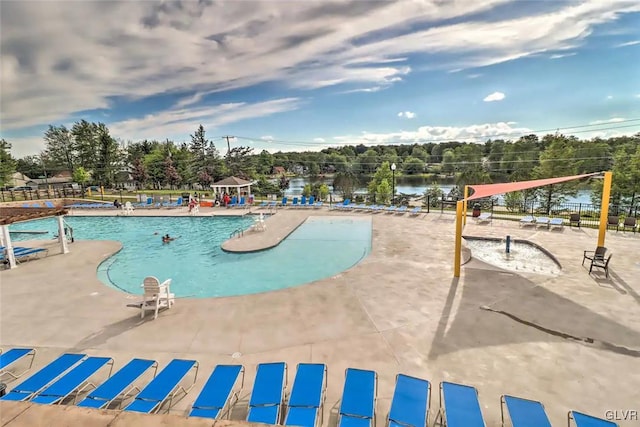 view of swimming pool with a patio and a water view