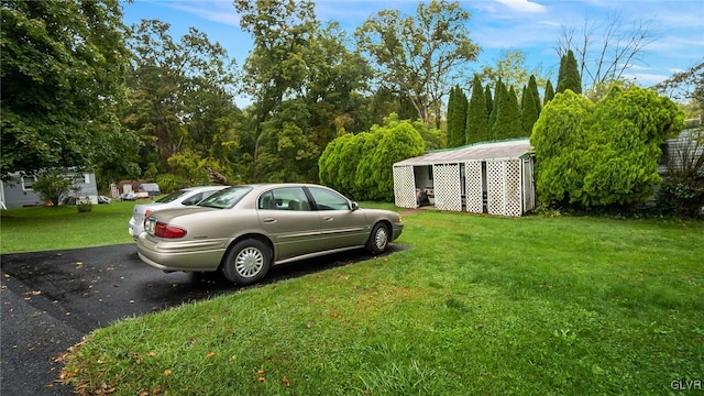 view of parking / parking lot with a lawn