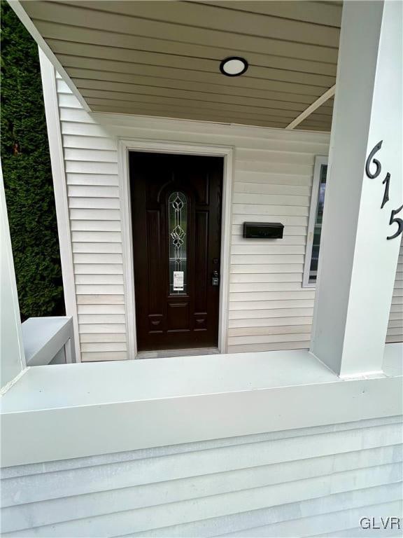 view of exterior entry with covered porch