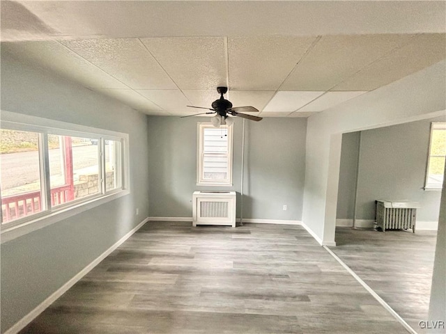 spare room featuring hardwood / wood-style flooring and plenty of natural light