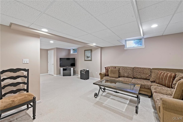 living room with light colored carpet and a drop ceiling