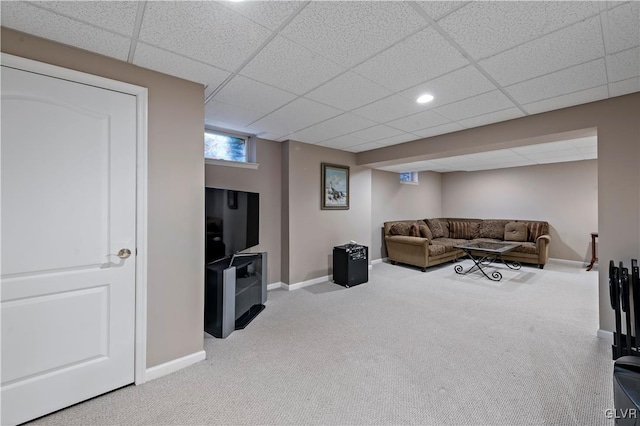 carpeted living room featuring a paneled ceiling