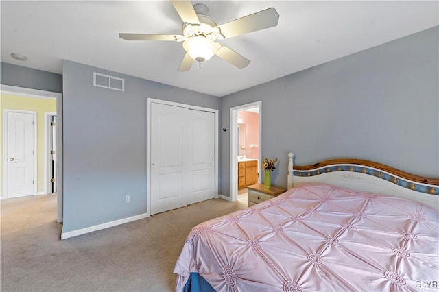 carpeted bedroom with ensuite bath and ceiling fan