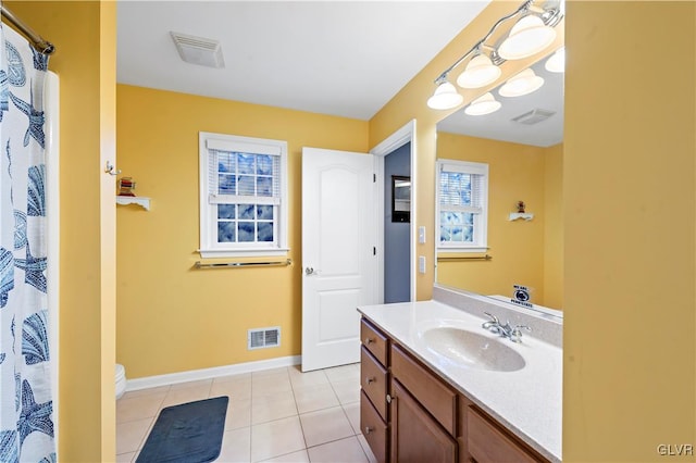 bathroom featuring tile patterned flooring, vanity, and toilet