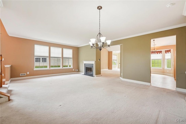 unfurnished living room featuring light carpet, crown molding, and a notable chandelier