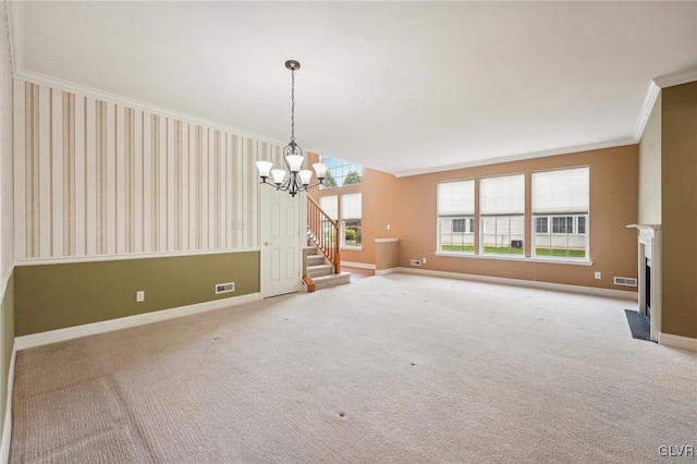 carpeted spare room featuring a chandelier, a wealth of natural light, and ornamental molding