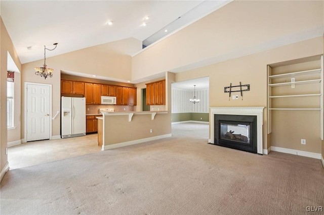 unfurnished living room featuring high vaulted ceiling, light colored carpet, and a multi sided fireplace