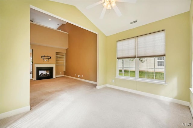 unfurnished living room featuring carpet floors, ceiling fan, and vaulted ceiling