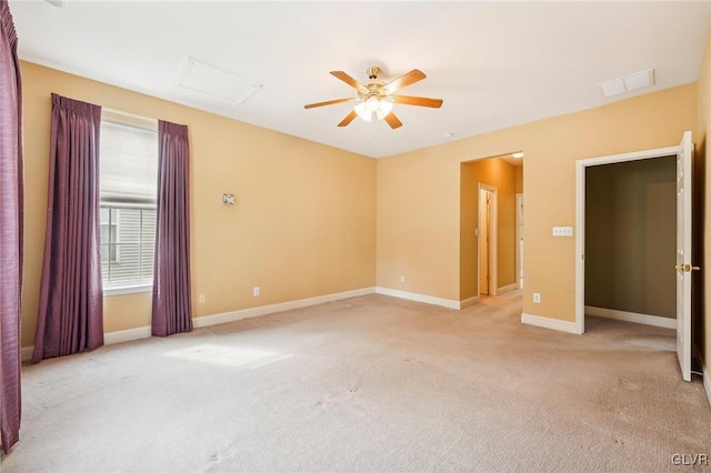 spare room featuring light carpet and ceiling fan