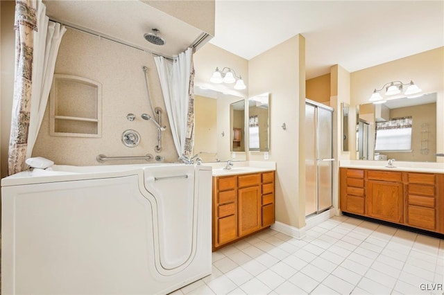 bathroom with washer / clothes dryer, tile patterned flooring, walk in shower, and vanity