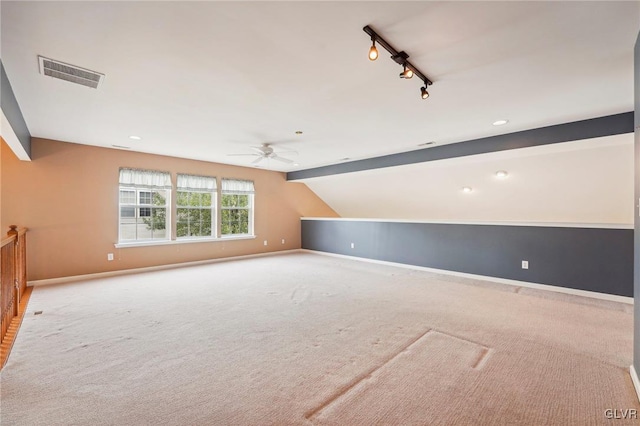 additional living space with ceiling fan, light carpet, and vaulted ceiling