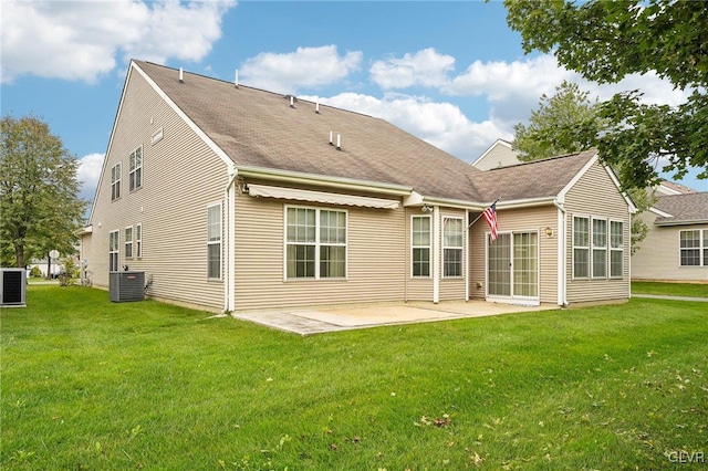 rear view of property featuring a patio area, central air condition unit, and a yard