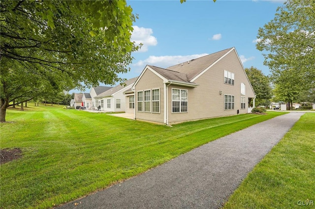 view of side of property featuring a yard