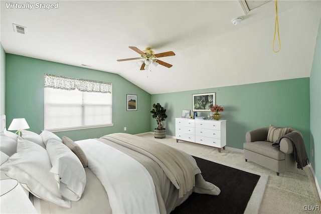 carpeted bedroom with vaulted ceiling and ceiling fan