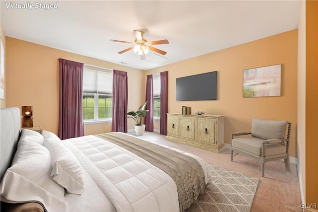 bedroom with ceiling fan and light colored carpet