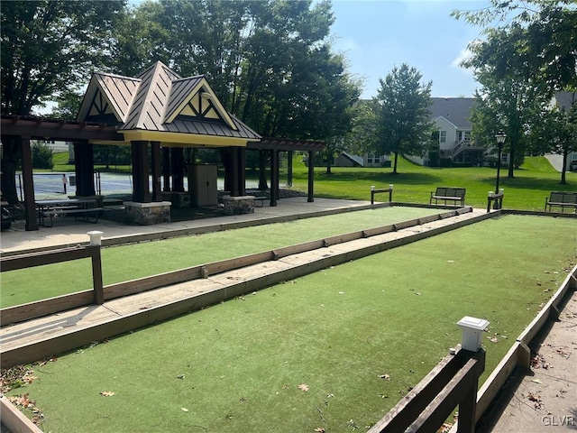 view of home's community with a lawn and a pergola