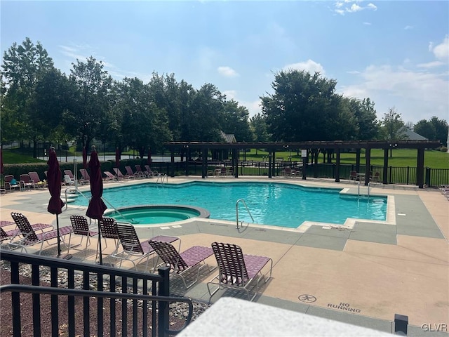 view of swimming pool featuring a community hot tub and a patio