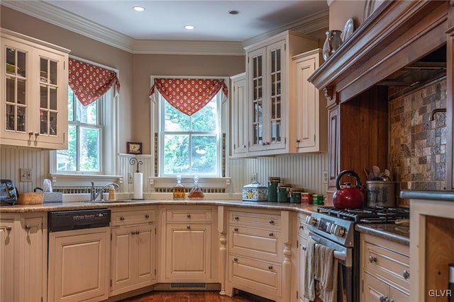 kitchen with light stone counters, sink, ornamental molding, high end stove, and dishwashing machine