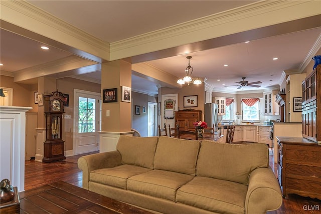 living room with ornamental molding, plenty of natural light, and dark hardwood / wood-style flooring