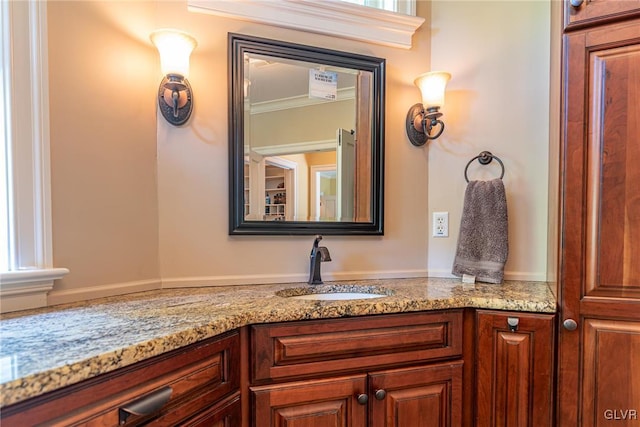 bathroom featuring ornamental molding and vanity