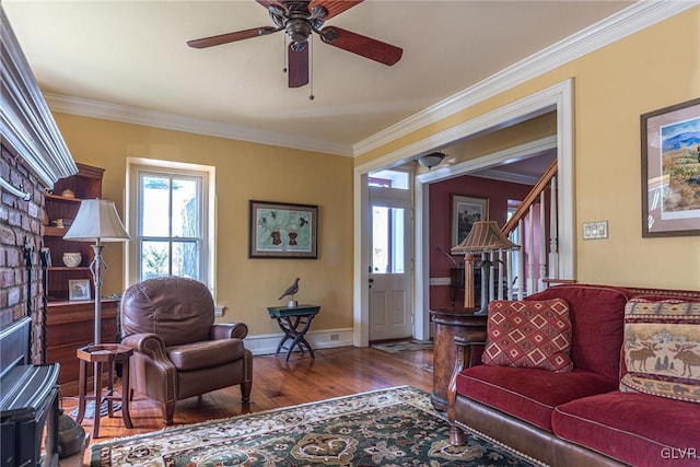 living room featuring ceiling fan, baseboard heating, crown molding, and hardwood / wood-style floors