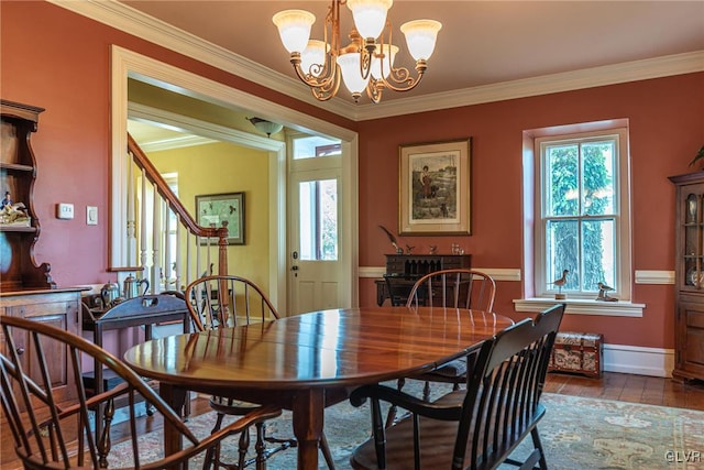 dining space featuring ornamental molding and an inviting chandelier