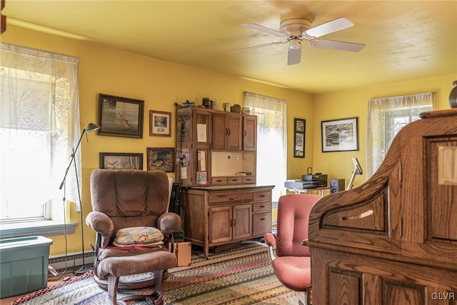 sitting room featuring ceiling fan