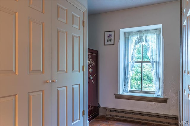 interior space with baseboard heating and hardwood / wood-style floors